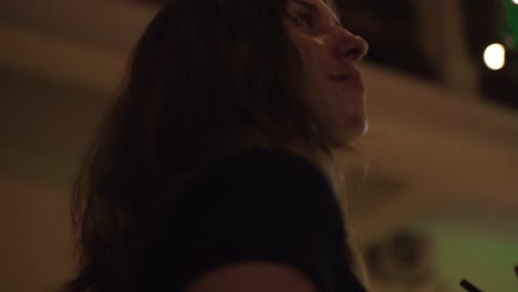woman enjoying a drink in a cafe at night