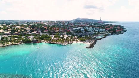 stunning blue caribbean water off coast of jan thiel, drone ascends above zanzibar beach