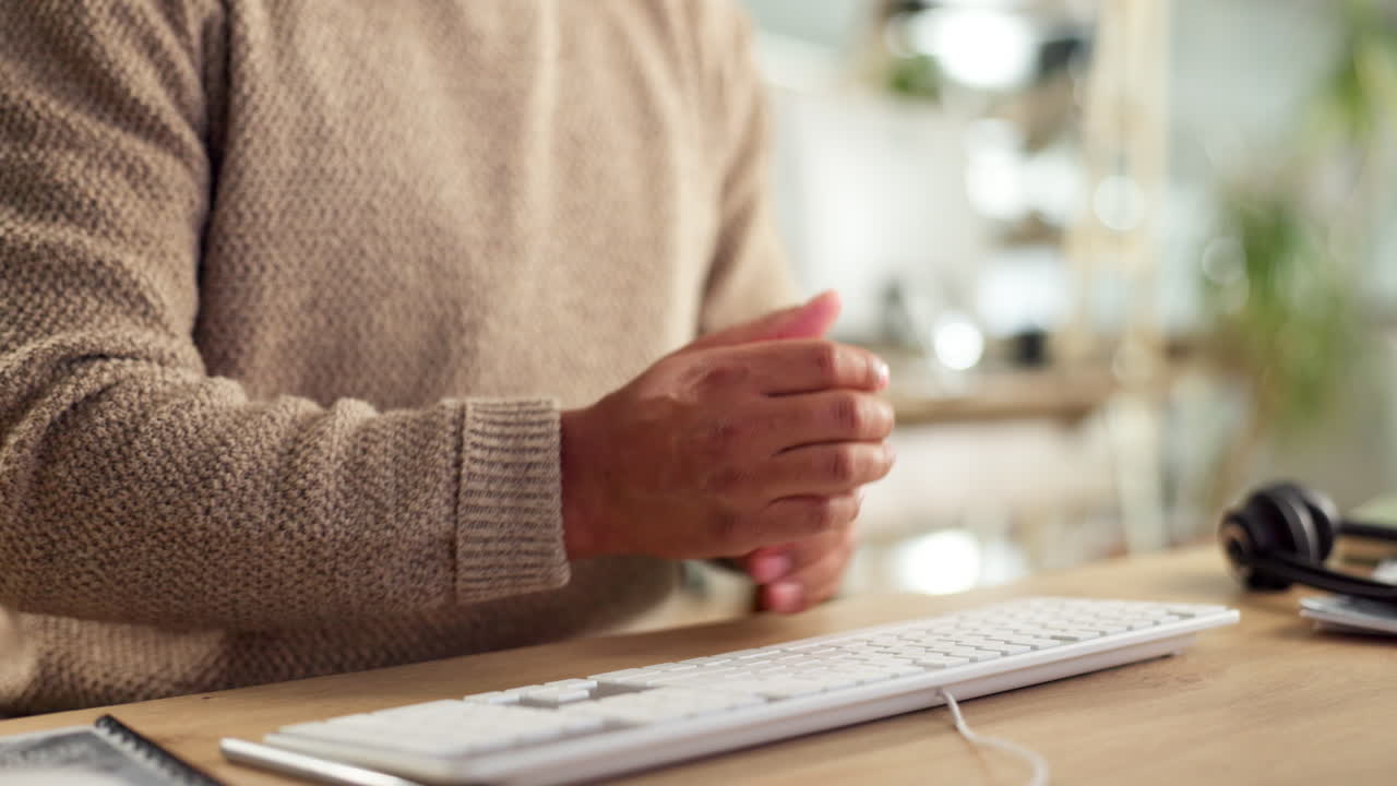 Person experiencing wrist pain in office