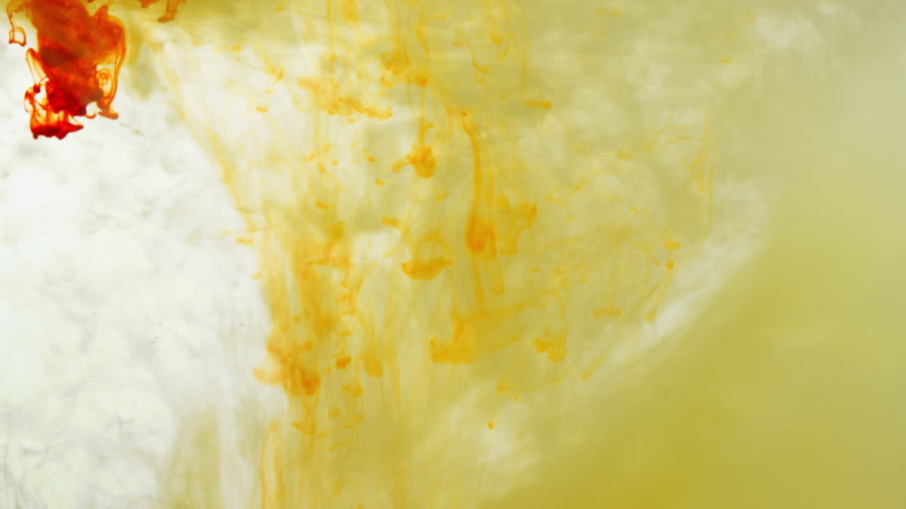 노란색과 오렌지색 페인트 또는 염료가 색 배경에 물에 떨어지면 회전하는 다채로운 연기 배경을 만니다.