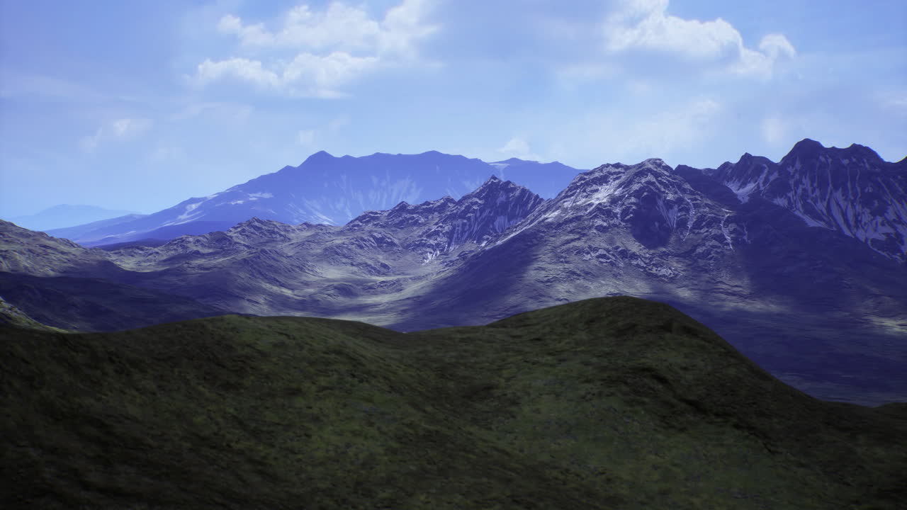 Majestic mountain landscape showcasing rolling hills and peaks under blue sky