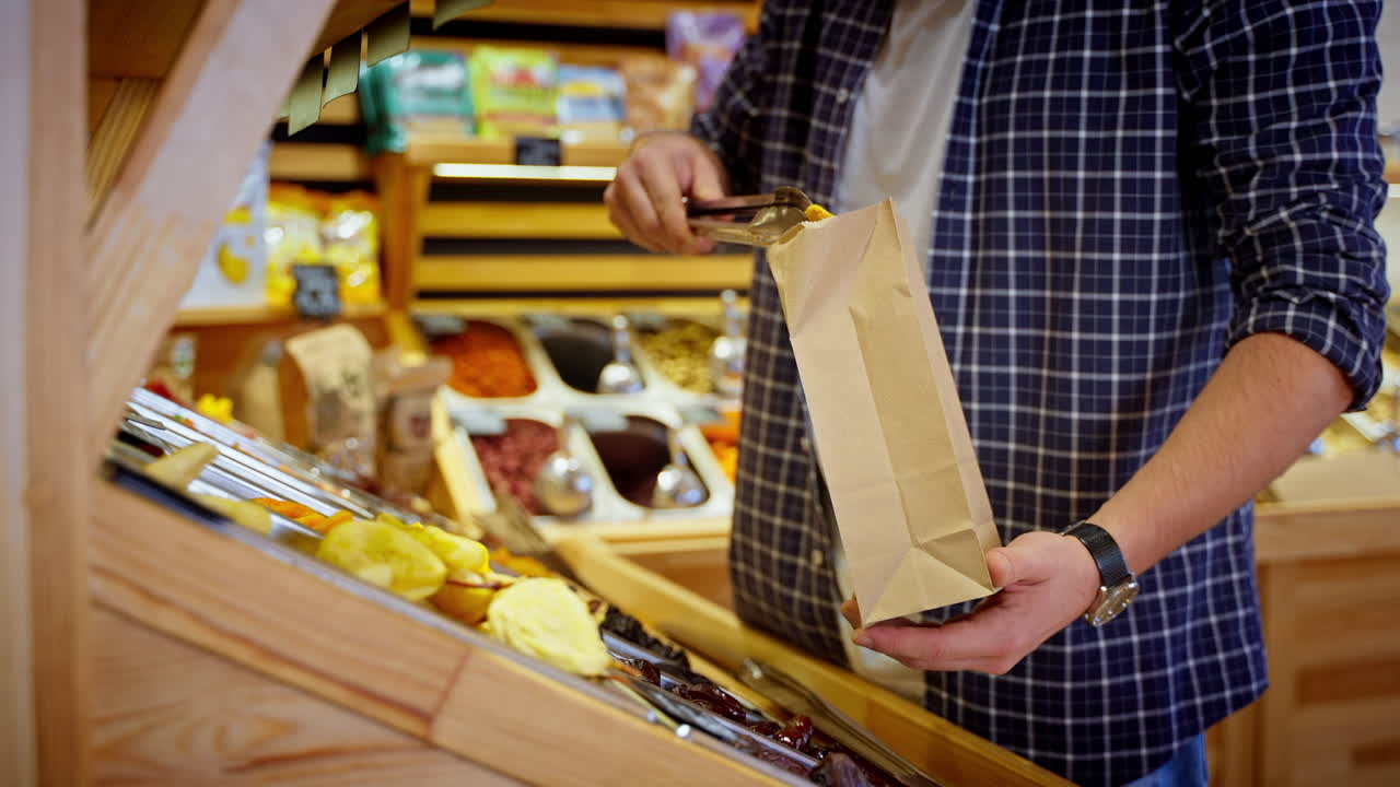 cliente comprando frutas secas y nueces en una tienda de comestibles