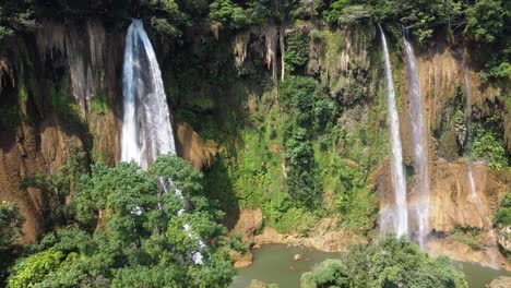 an aerial rotational drone shot of one of the huge waterfalls of thi lo su waterfall, located off the beaten track in the backpacker's paradise of north thailand in the area of umphang