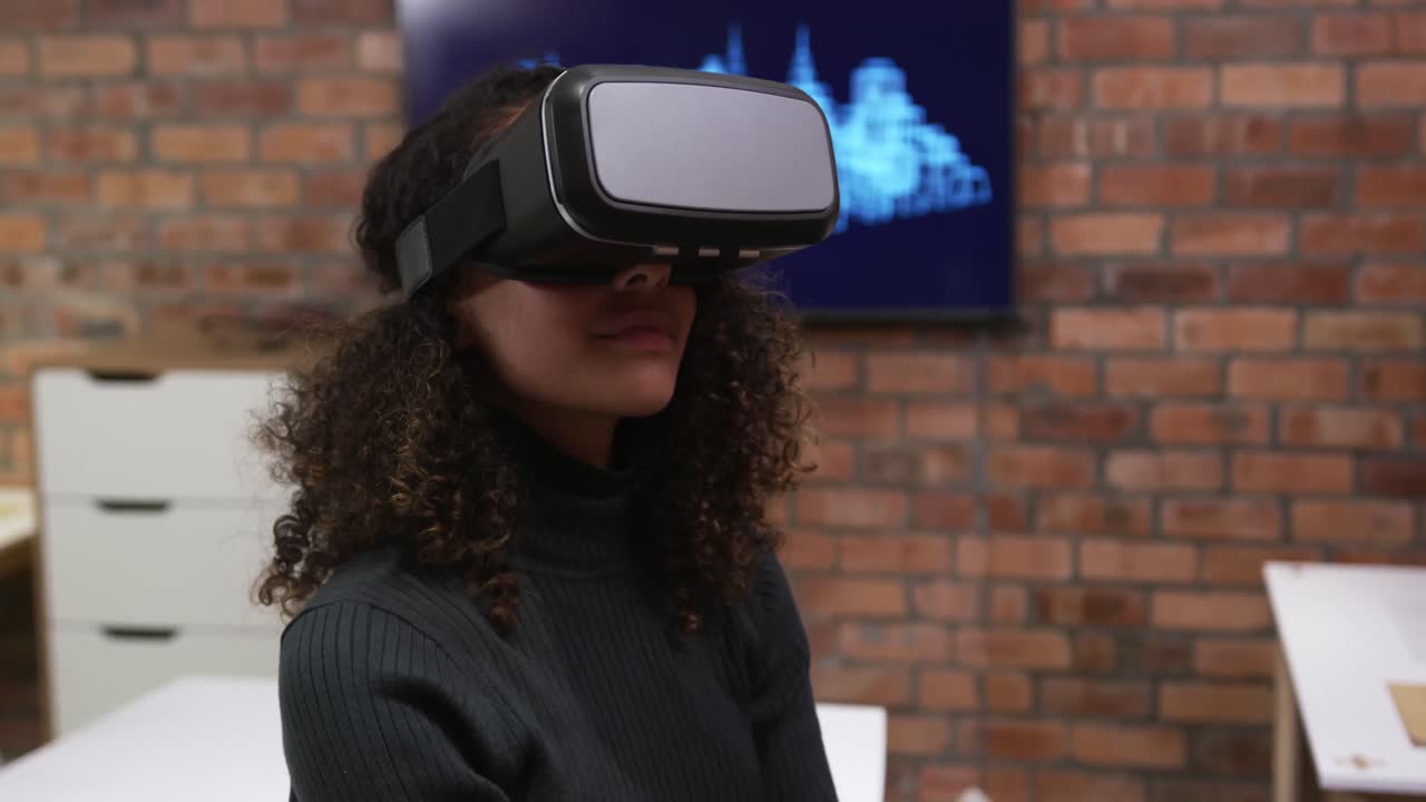 Creative businesswoman using virtual reality headset in modern office