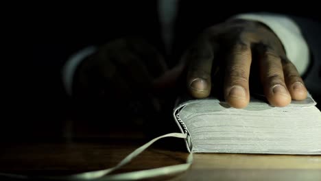 praying-to-god-with-bible-on-table-with-people-stock-video-stock-footage