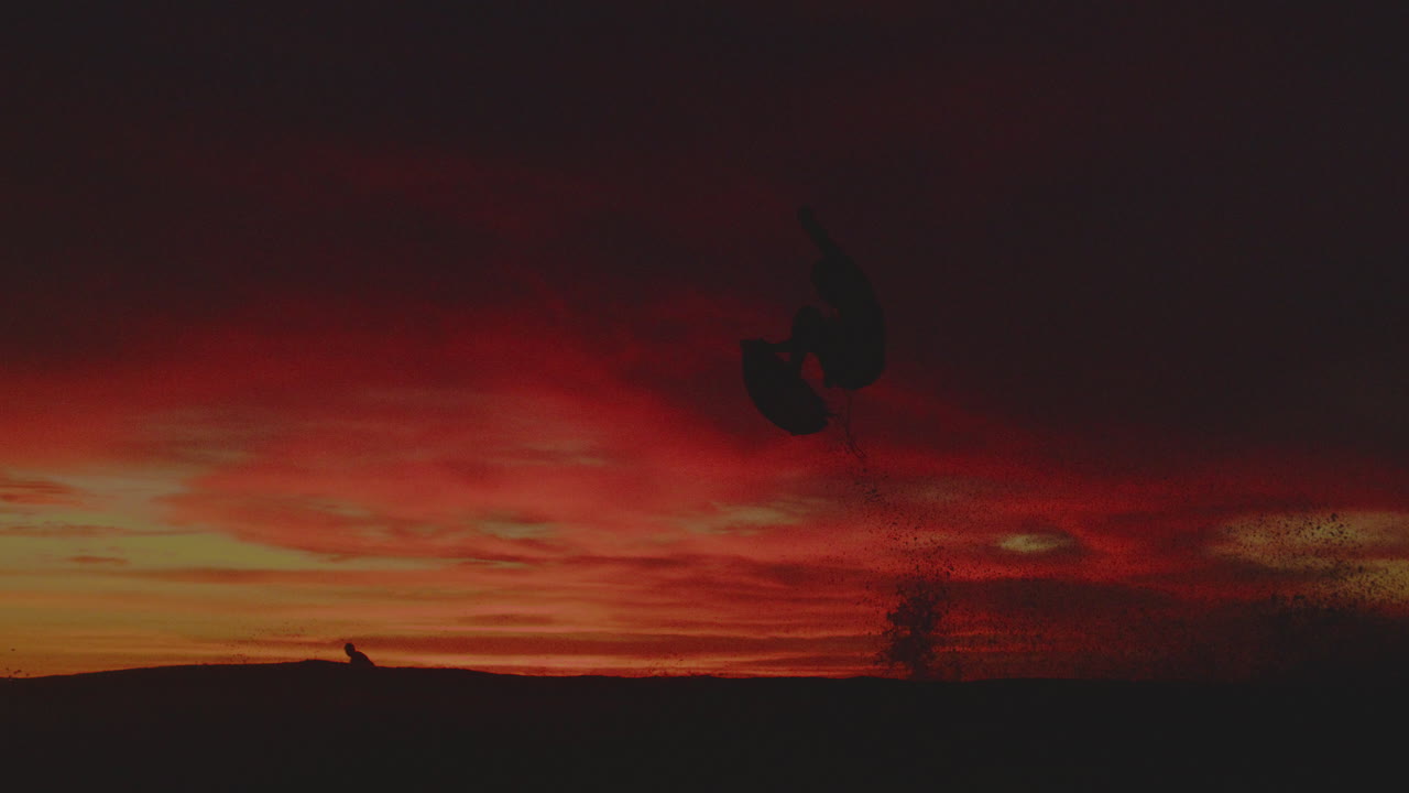 Surfer Takes on the Sunset Waves