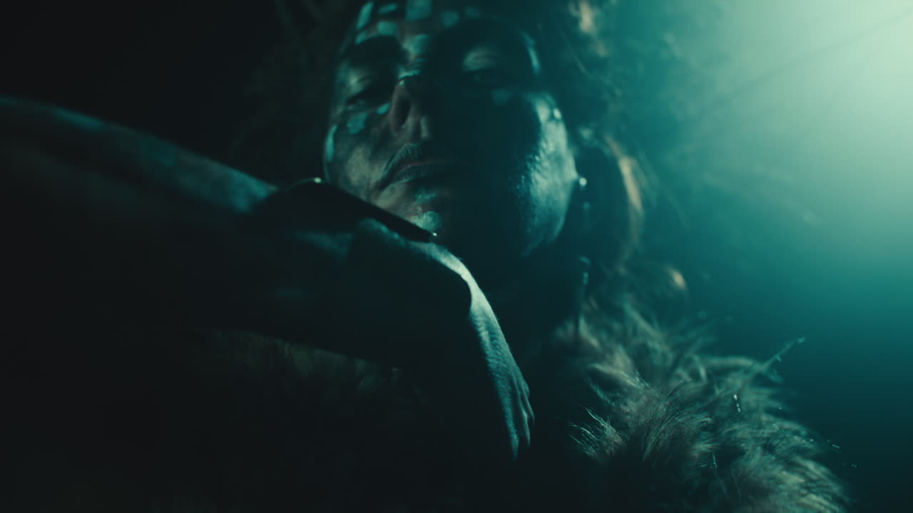 The witch makes a gesture of cutting her throat