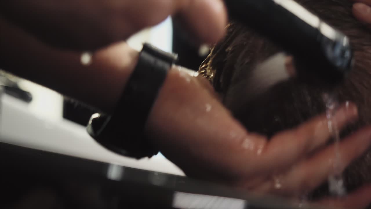 Man getting his hair washed at a barbershop