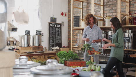 young couple buying fresh fruit and vegetables in sustainable plastic free grocery store