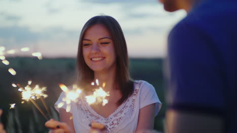 young couple having fun with fireworks slow motion 10 bit video