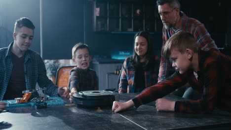 family learning about robotics and technology with a robot vacuum