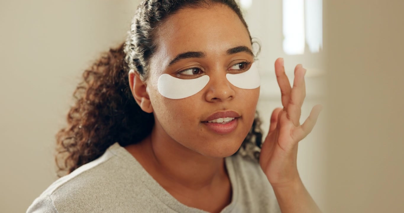 Young Woman Applying Under-Eye Patches for Skincare Routine