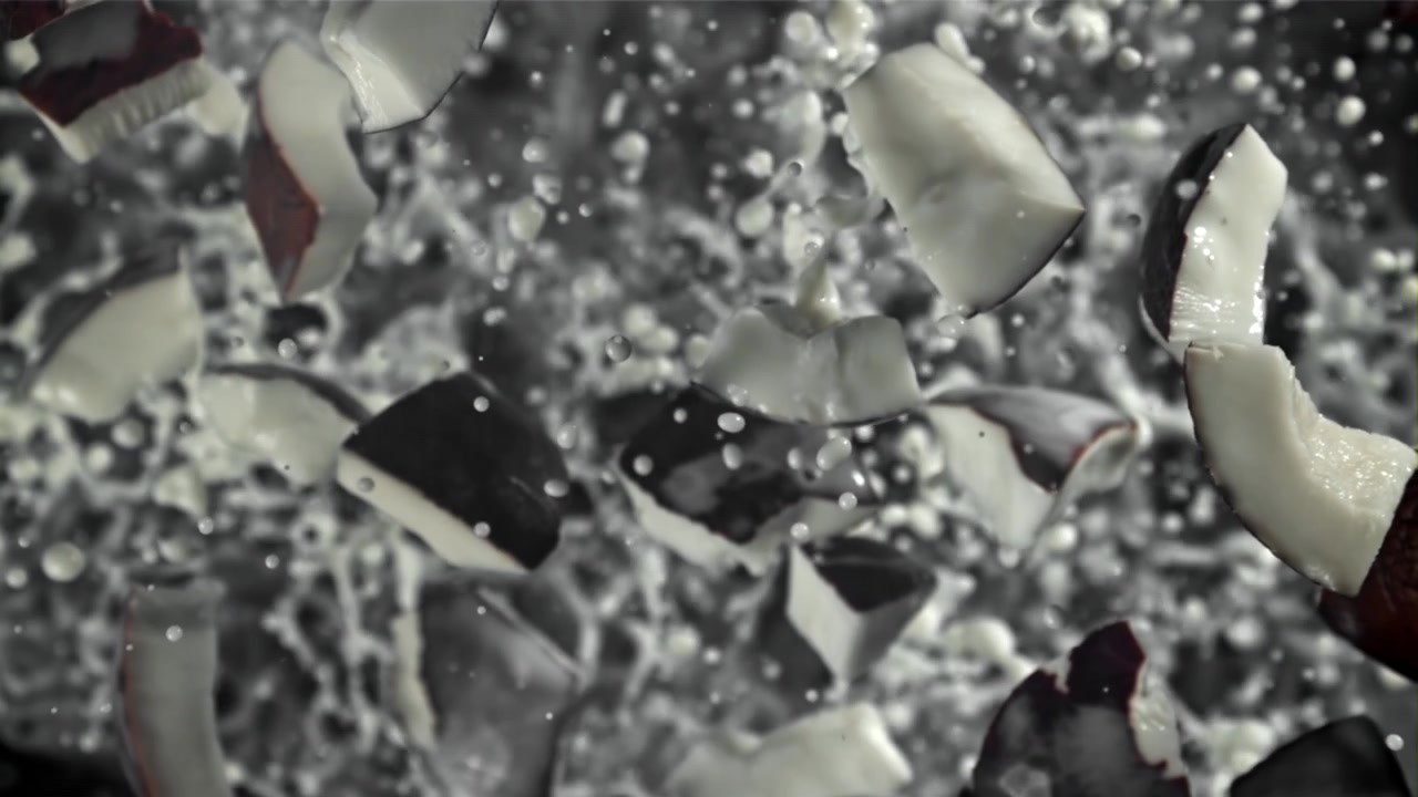 Slow Motion of Coconut Pieces Splashing in Milk