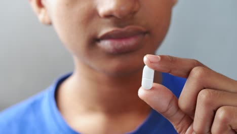 child holding a pill