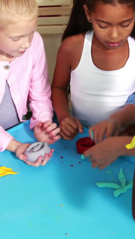 cute classmates playing with clay