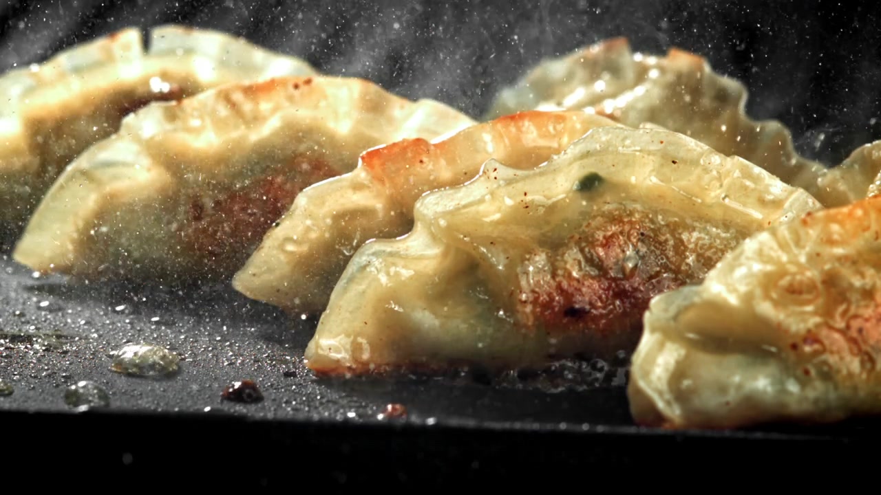 Delicious Golden Brown Dumplings Frying in a Hot Sizzling Pan