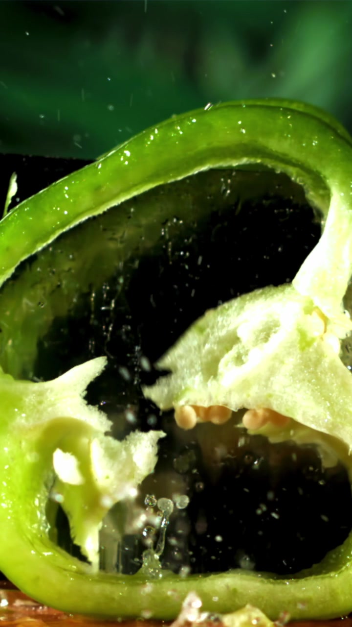 Water Splashing on Fresh Green Bell Pepper Halves in Slow Motion