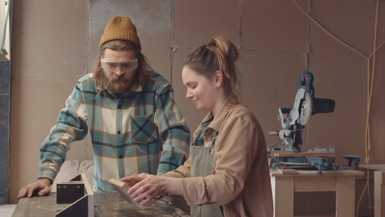 Two Joiners Working Together in Joinery Workshop