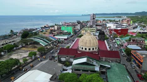 aerial orbit of city traffic and cathedral, virac, catanduanes, philippines