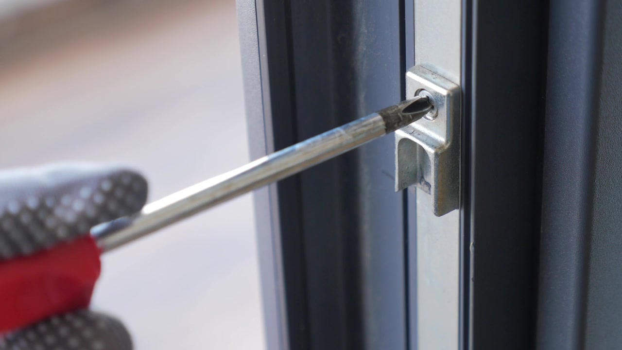Hand in Glove Tightening Screw on Window Frame