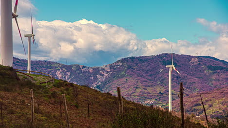 Static-view-of-white-wind-turbines-moving-in-timelapse