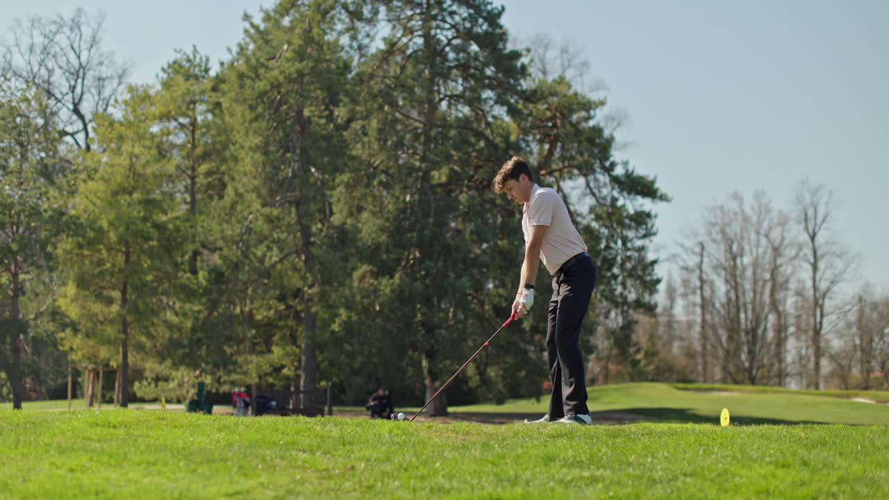 Young golfer playing on a sunny spring day in Switzerland, showcasing precise chipping, putting, bunker, and approach shots. Perfect for sports, lifestyle, and outdoor themes.