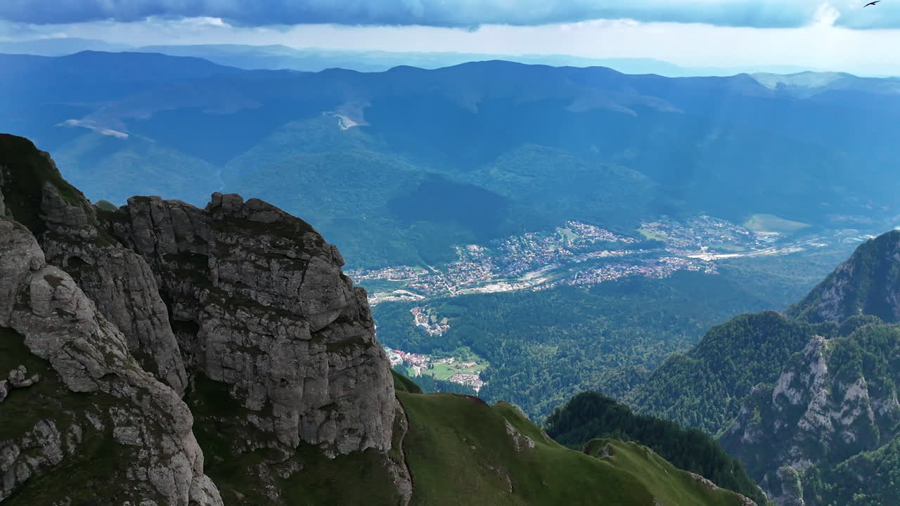 Explore the mountains and valleys of Busteni Romania. Beautiful landscape showcasing Busteni, Romania with stunning mountains and a lush valley under a cloudy sky