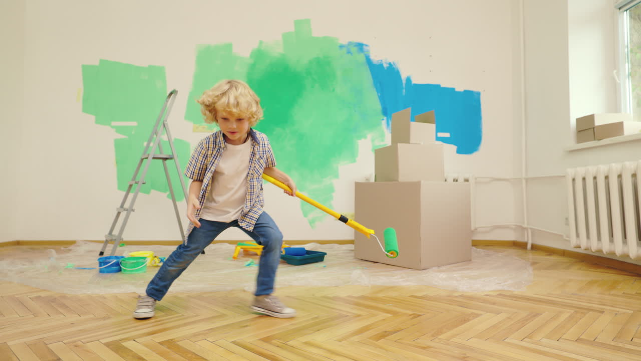 Child Playing with Paint Roller in a Room Under Renovation