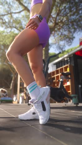 woman's legs and athletic shoes during outdoor workout