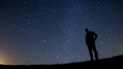 man standing under a starlit sky