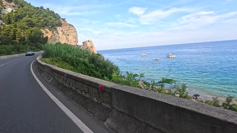 motorbikes and cars on a coastal road