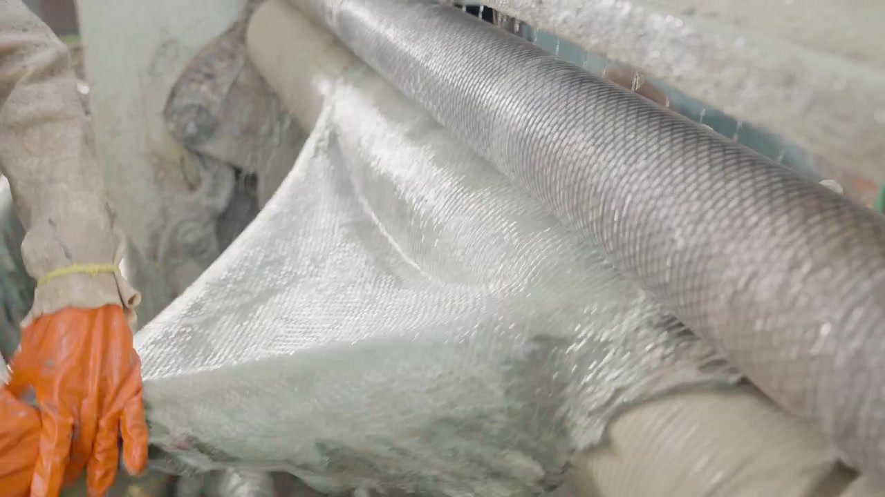 Worker Placing Animal Hides In A Wet Industrial Machine During Production Of Leather.