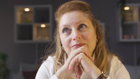 Elderly-woman-sitting-at-home-and-daydreaming.