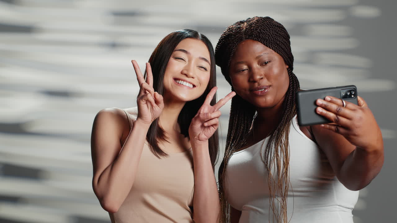 Two women taking selfies