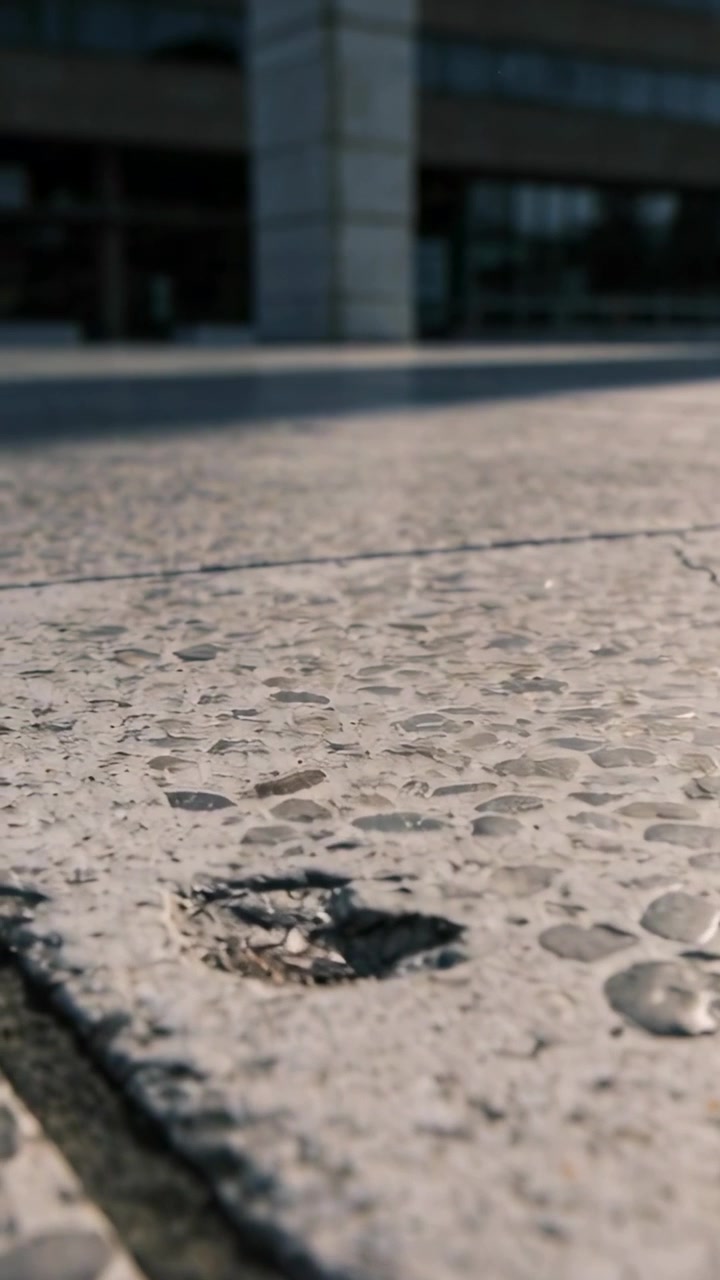 Vertical video: Sliding shot starting low revealing terrazzo floor at entrance, documenting pothole