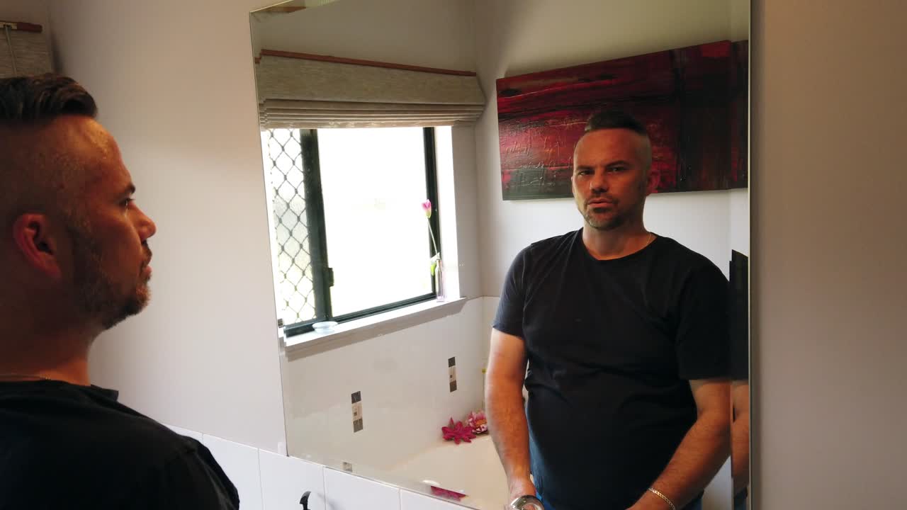 man talking to the camera, saying no by shaking his head to three different questions in slo motion