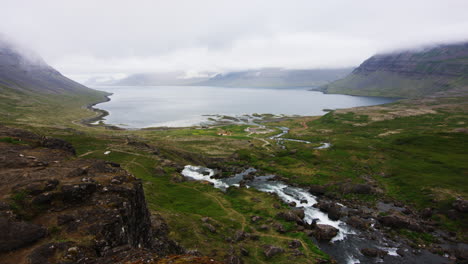 cinematic view of vibrant mountain landscape down at dynjandisvogur fjord