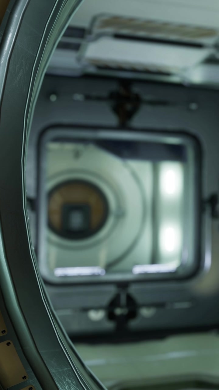 View of a spacecraft interior through a round opening in space station