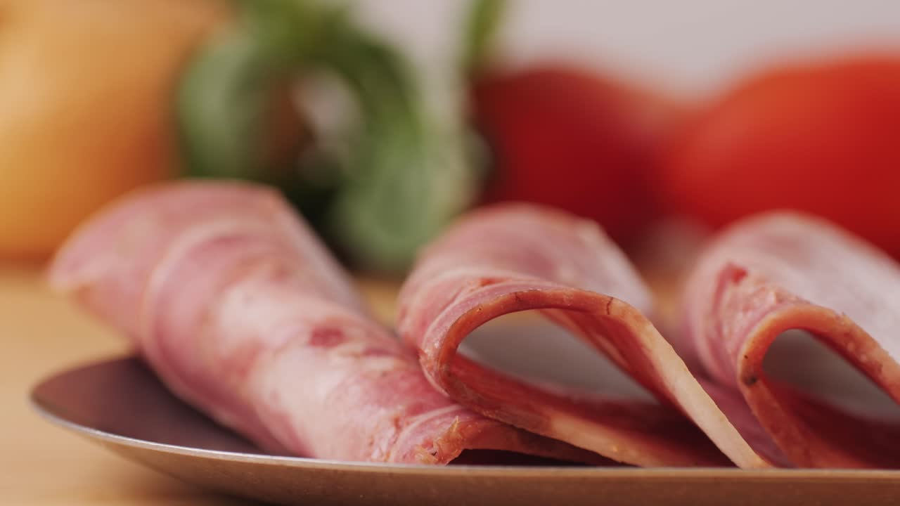black bull sausage ham, tongue pork dry-cured sausage on a black background, traditional spanish delicatessen food, close up.
