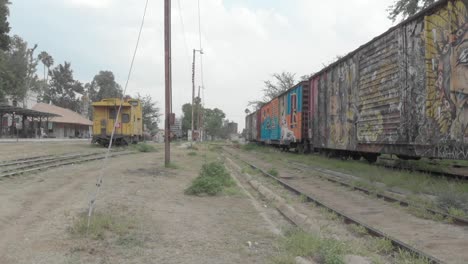 a cinematic view of a colorful wagnor in a rail station