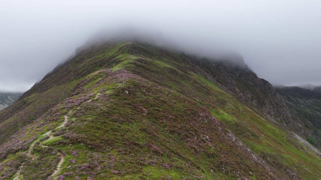 Drone footage of a misty ascent of Fleetwith Pike's craggy ridge in the Lake District National Park
