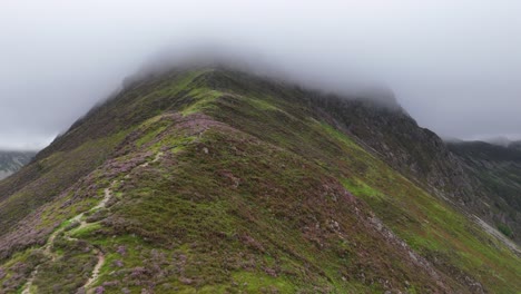 drone footage of a misty ascent of fleetwith pike's craggy ridge in the lake district national park