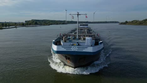 Backwards-fly-around-front-tip-of-motor-tanker-ship