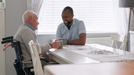 elderly man and caregiver conversing at table