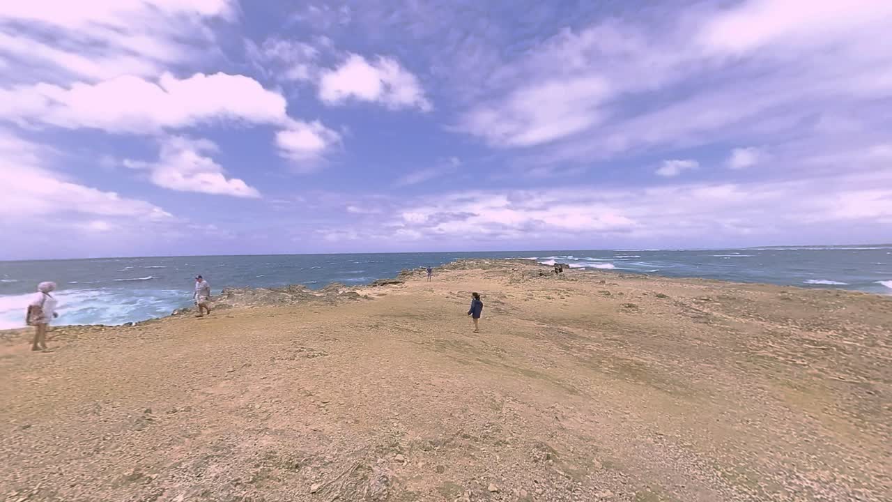 Cinematic reveal of a historic lighthouse ruins overlooking the Indian Ocean in Mauritius. Dramatic unveiling showcases the weathered structure and stunning seascape.