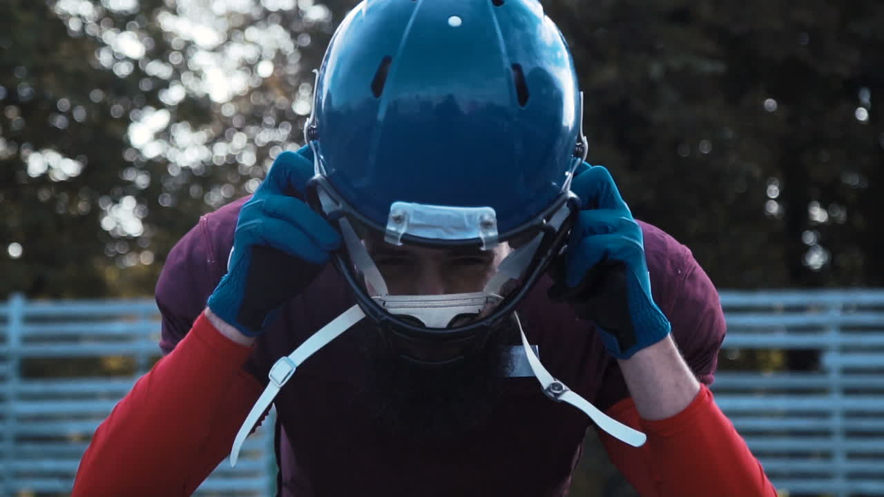 Football Player Adjusting Helmet