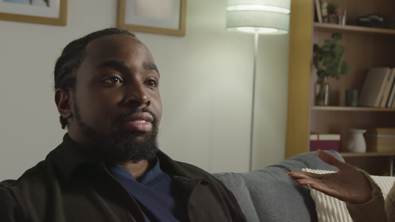 Couple At Home Sitting On Sofa In Lounge Having Breaking Up Argument 7