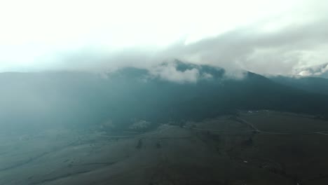 toma de un dron de un campo y una montaña con cielo nublado