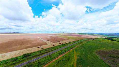 capturing an aerial view of soybean harvesting in the rural landscape of são joão da aliança, goiás, brazil, highlighting vibrant agricultural activity beneath a cloudy sky