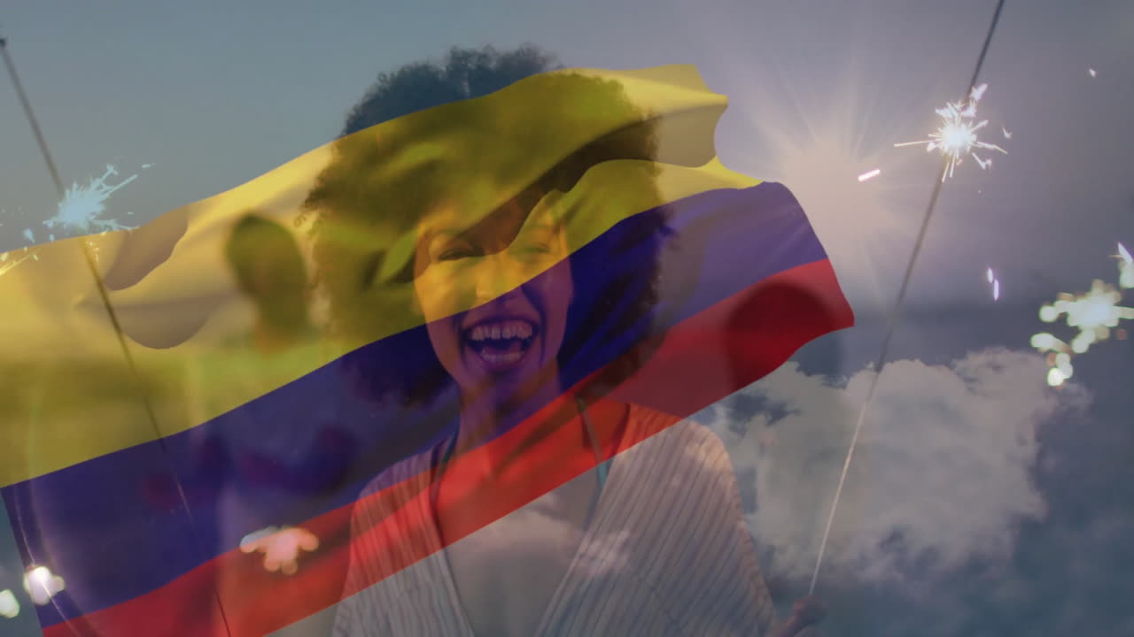 Holding sparklers, woman celebrating over Colombian flag at sunset with animation